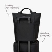 Black tote bag and carry-on bag stacked on a white background.