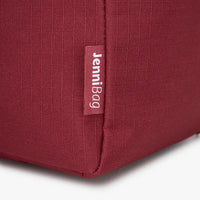 Close-up of a red bag with a label