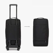 Black rolling suitcase and standalone bag on a white background